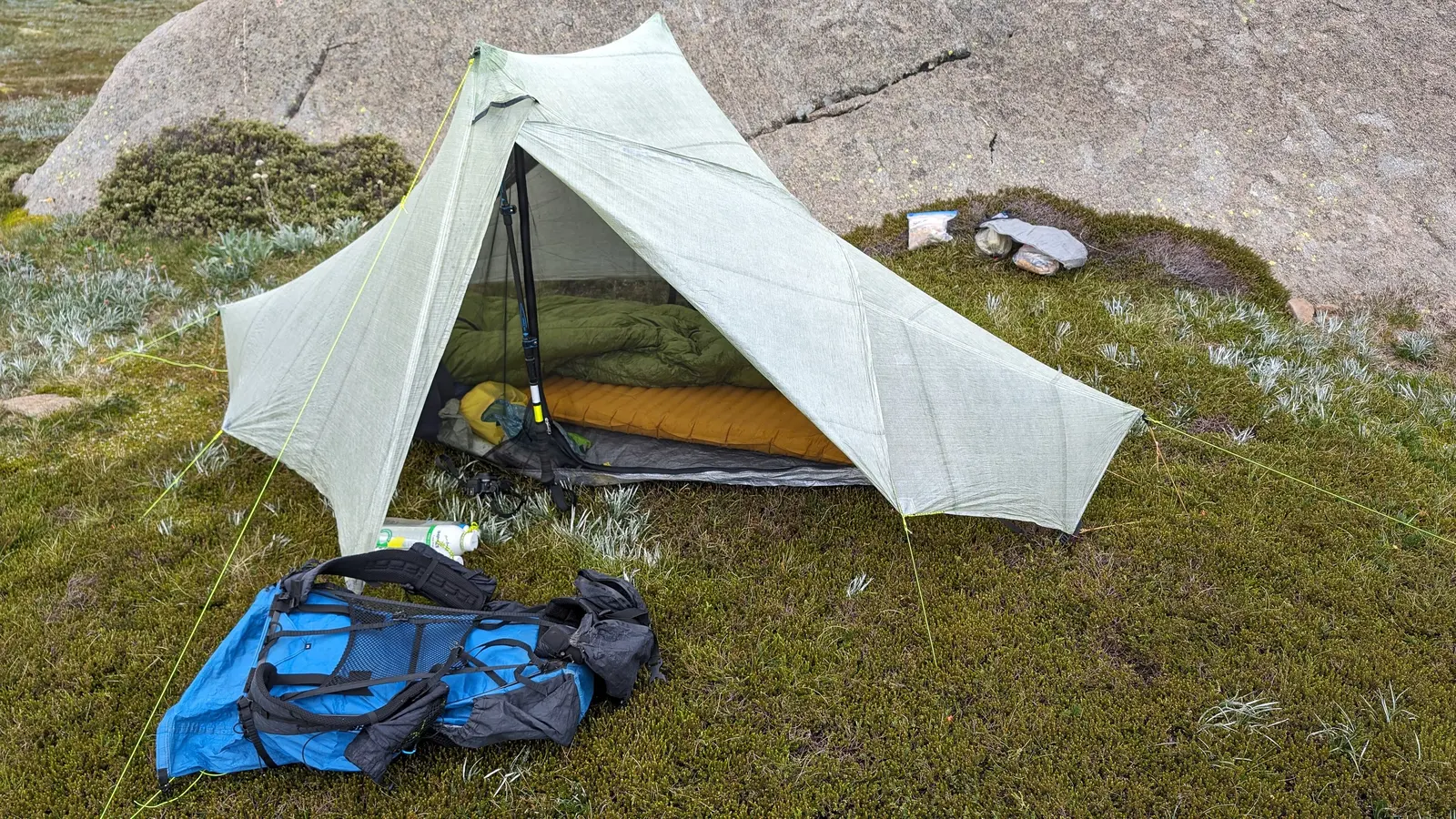 Camping equipment packed beside a vehicle