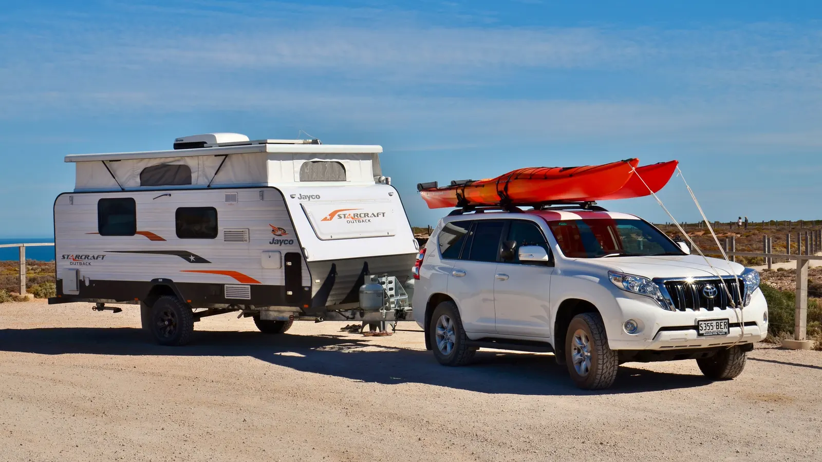 Car and caravan travelling on an Australian road